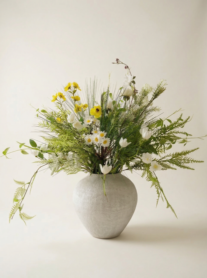 Vase with a bouquet of flowers on a light background